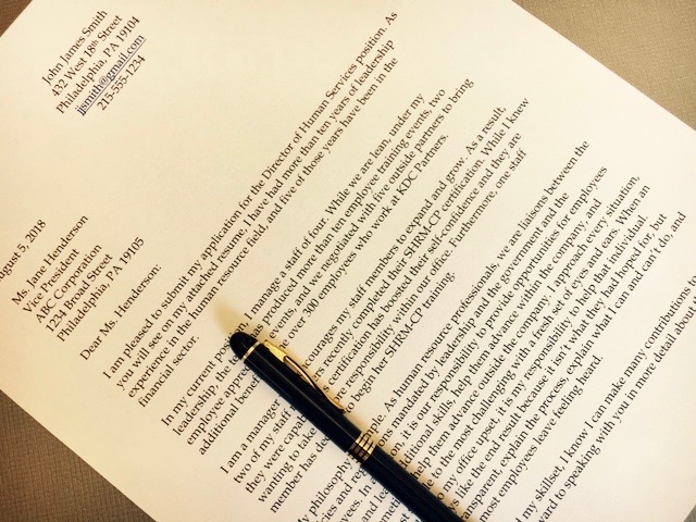 Image of a cover letter with a pen sitting on top of the letter